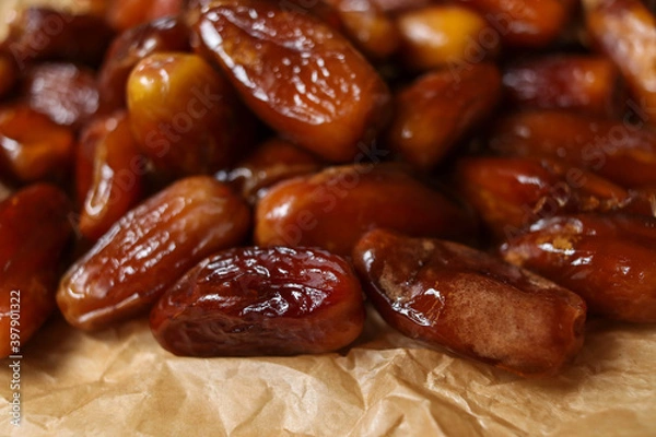Fototapeta Close up of date fruits placed on brown paper