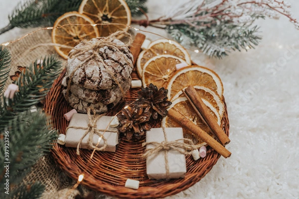 Obraz Still life details in home interior. Cozy winter concept with cinnamon, pine cones, cookies, marshmallows and gifts