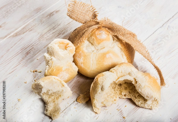 Fototapeta michetta bread over white wooden table