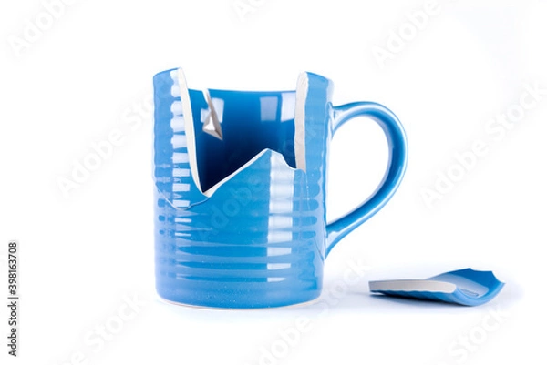Fototapeta Broken blue mug with a shattered piece laying next to it