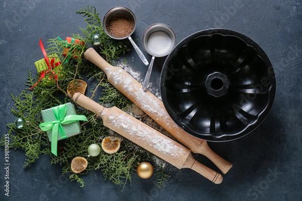 Fototapeta Ingredients for Christmas bakery and kitchen utensils on dark background