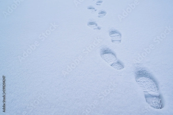 Obraz Footsteps on the snow-white snow at dusk.
