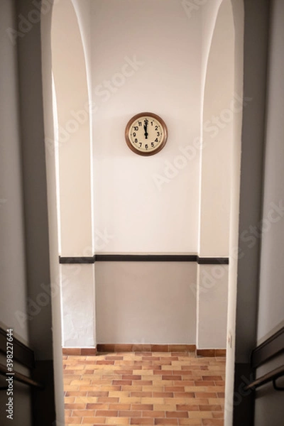 Obraz A clock on the portal of a house.