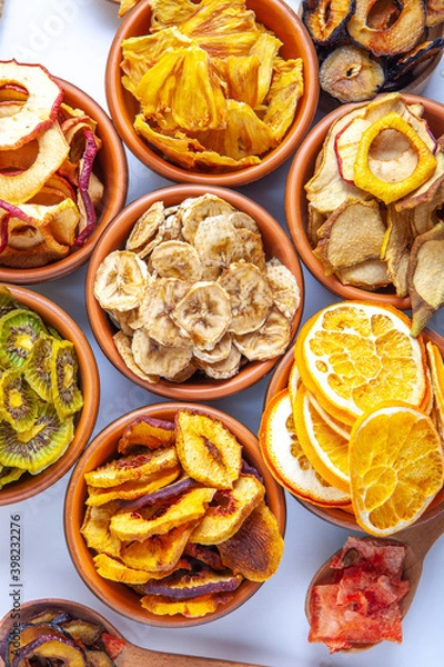 Fototapeta Organic Healthy Assorted Dried Fruit Mix close up. Dried fruit snacks. dried apples, mango, feijoa, dried apricots, prunes top view