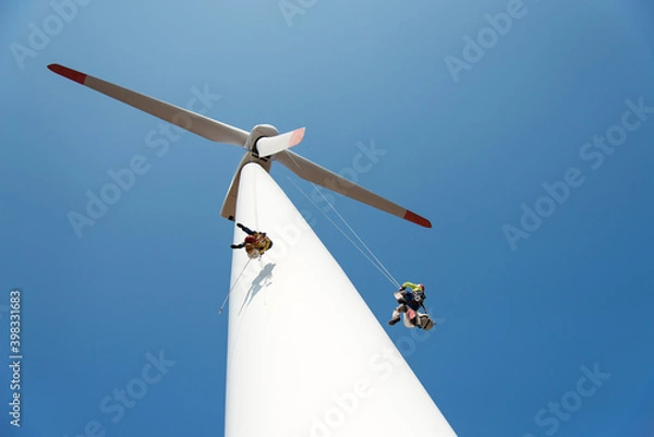 Fototapeta repair work on the blades of a windmill for electric power production - copy space