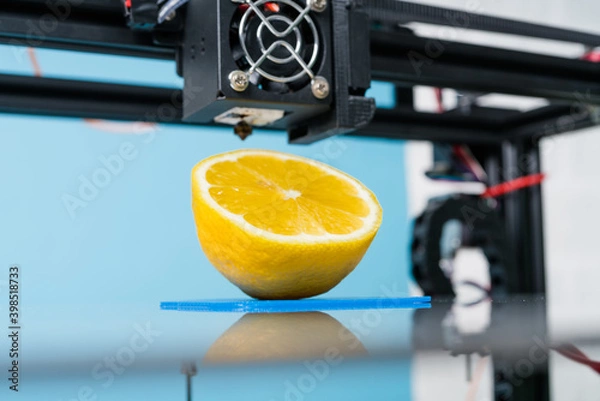 Fototapeta Ripe slice of yellow lemon citrus fruit . 3d printer of the device during the processe
