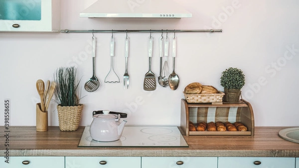 Fototapeta Bread box on the kitchen table with a different kind of dough. The kitchen also has a stove on which there is a kettle, and nearby are cutlery.