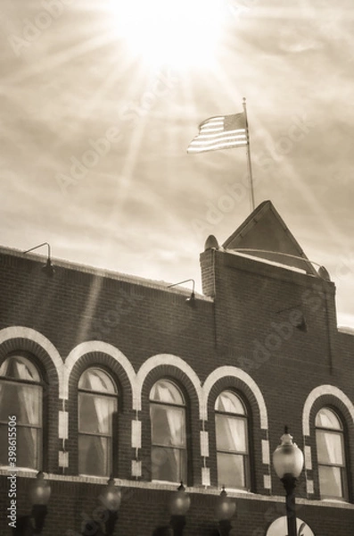 Fototapeta Flag flying high on building
