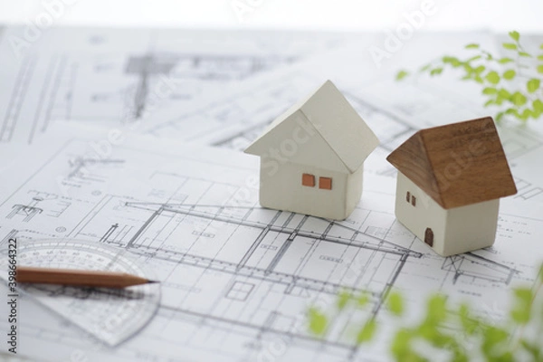 Obraz 木でできた家の模型とマイホームの設計図のイメージ