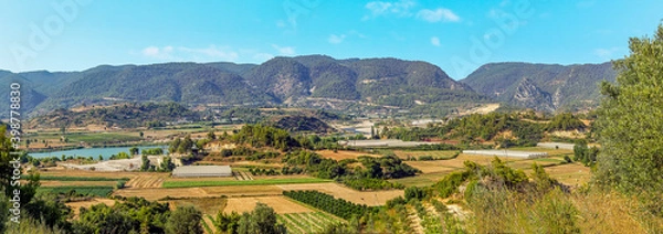 Fototapeta A view across the Alaharan valley looking towards the hilltop Alara fort in the distance in Turkey in summertime