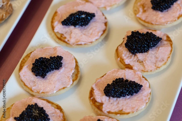 Obraz Blinis with taramasalata and lump-fish roe on a white dish