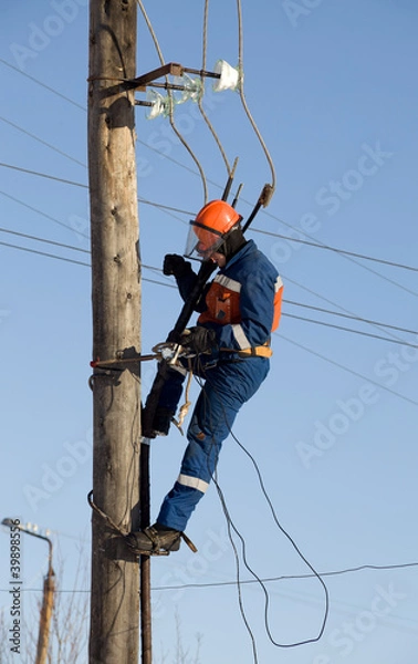Fototapeta Electrician working at height with wires