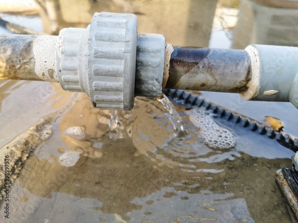 Fototapeta humid leaking pipe of a central air conditioning system and cold water drops on it