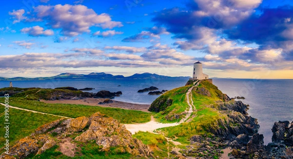 Fototapeta Sunset view of Lighthouse on Llanddwyn Island at the coast of Anglesey in North Wales,UK