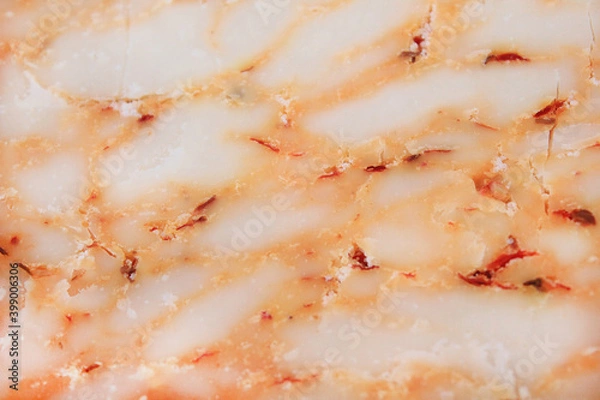 Fototapeta farmer's cheese crust of the cheese with the beans inside. texture as they Mature-hand-job. pieces of cheese on a cutting Board in different colors-orange marble Derby with paprika and tomato
