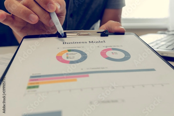 Fototapeta Close up of a business man working with diagrams.