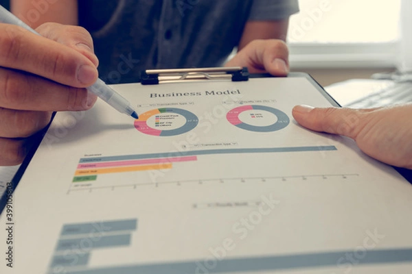 Fototapeta Businessman working with diagrams. Close up of hands and documents. Online education.