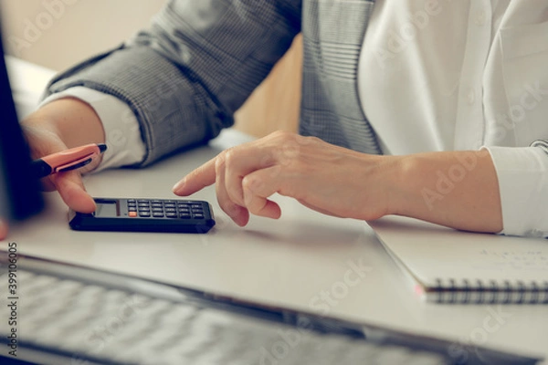 Fototapeta Close up of business lady hands calculating earnigs business performance
