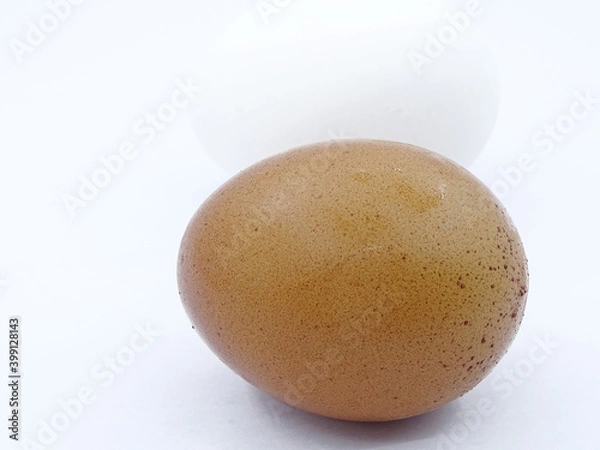 Fototapeta Brown and white eggs against a white background. Organic village eggs provide higher protein