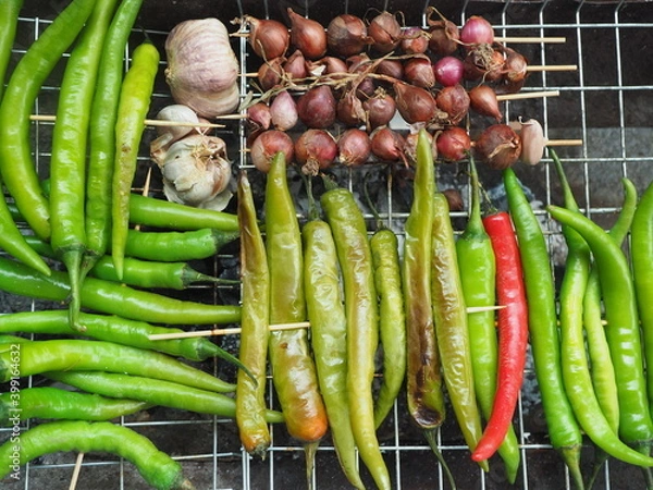 Obraz Young green chilli grill on Grill grate before cooking Northern Thai Green Chilli Dip, Called "Nam Prik Num", Selective focus.