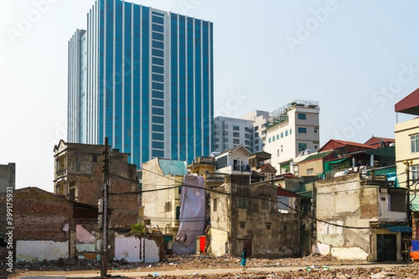 Fototapeta Ruin houses on highrise building background contrast on Minh Khai street, Hanoi, Vietnam