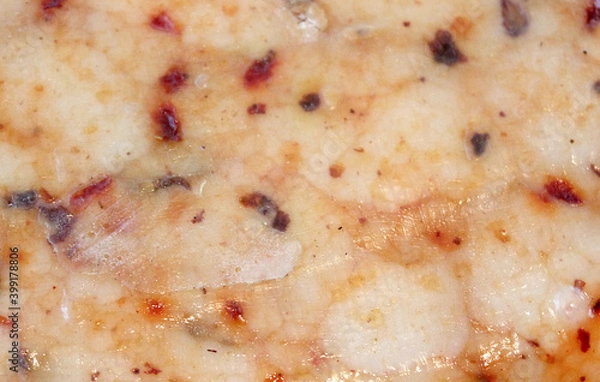 Fototapeta Farmer's cheese crust of cheese with grains inside. texture as hand-made cheeses ripen. orange white green solid background, cheese mold