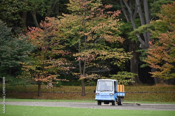 Fototapeta The grass field caretakers with the pick-up car in Sapporo Japan