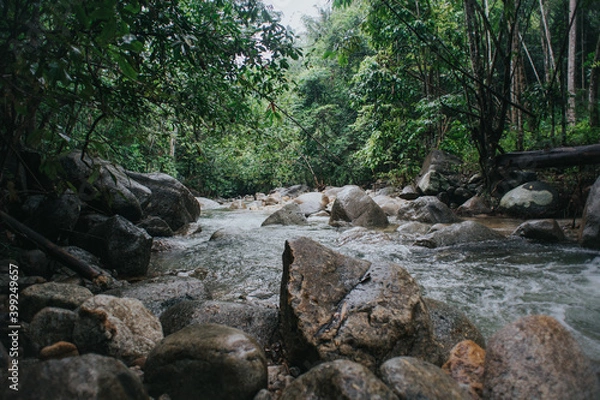 Obraz Beautiful waterfall stream in tropical rainforest scenery in the morning in slow shutter mode.Selective focus shot.Image contain grain due to slow shutter shot.