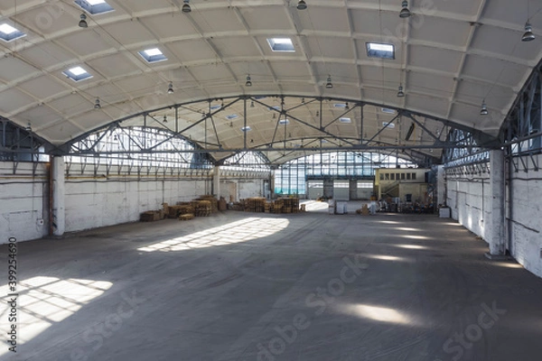 Fototapeta Huge industrial warehouse. Modern interior. Unique architecture. Hemispherical reinforced concrete load bearing roof. Stack wooden pallets.