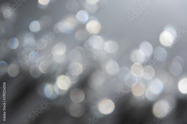Obraz Abstract bokeh effect background in grey colours with rainbow rays.