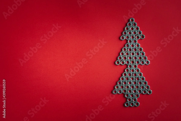 Obraz Christmas tree made of silver metal nuts. Winter holidays concept. Creative modern idea. Flat lay, top view, copy space