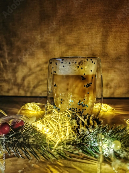 Fototapeta New year's and Christmas  composition: a Cup of cappuccino, a branch of spruce and garlands