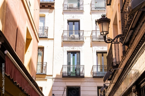 Fototapeta Old historic houses with windows, balconies and streetlight in Madrid