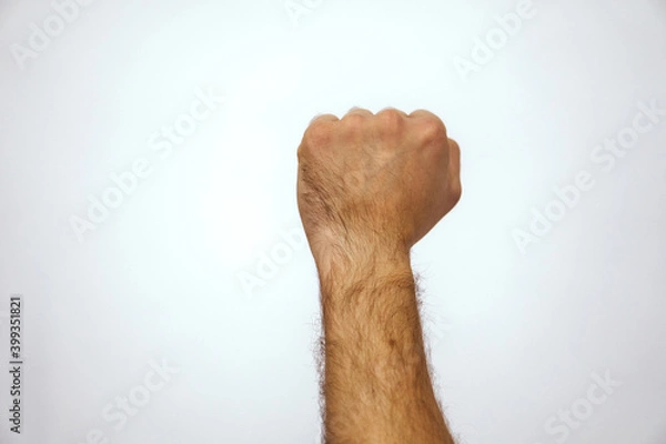 Obraz Male fist up and The victory of a strong Caucasian man. Strong hand on a white background. High quality photo