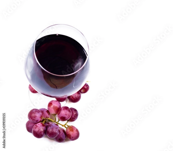Fototapeta wine glass with red wine and grapes