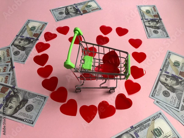 Fototapeta  shopping cart in the centre of the heart made of small red hearts and banknote one hundred dollars 