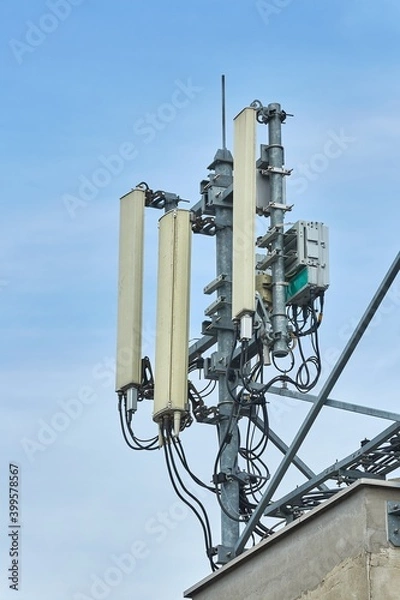 Fototapeta Signal transmitters for mobile network on a building roof