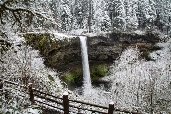 Fototapeta A wide angle view of South Falls at Silver Falls State Park after a snow storm - Silverton, Oregon