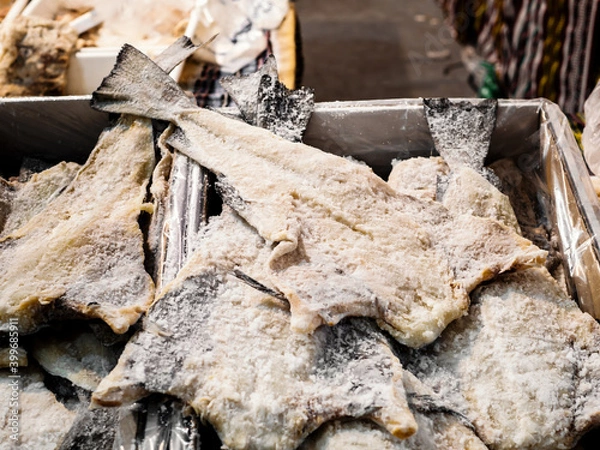 Fototapeta bulk of salted and dried cod fish in a market hall