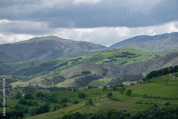 Fototapeta Mountain landscape against cloudy sky