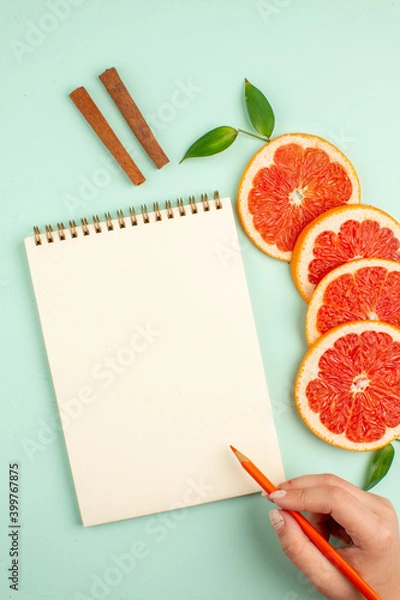 Fototapeta top view tasty fresh grapefruits with notepad on light-blue background health fruit diet fresh juice color