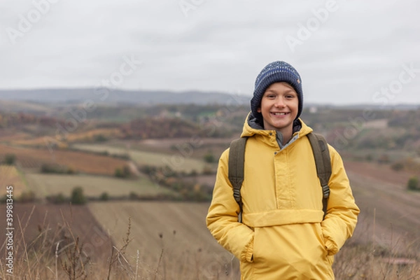 Fototapeta Happy little boy enjoying on a hill in autumn day.