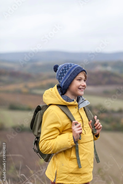 Fototapeta Happy little boy enjoying during autumn day on a hill.