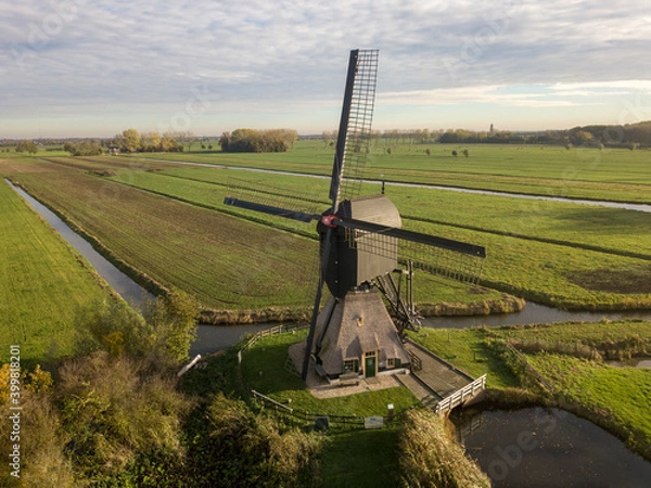 Obraz Windmill in a typical Dutch landscape