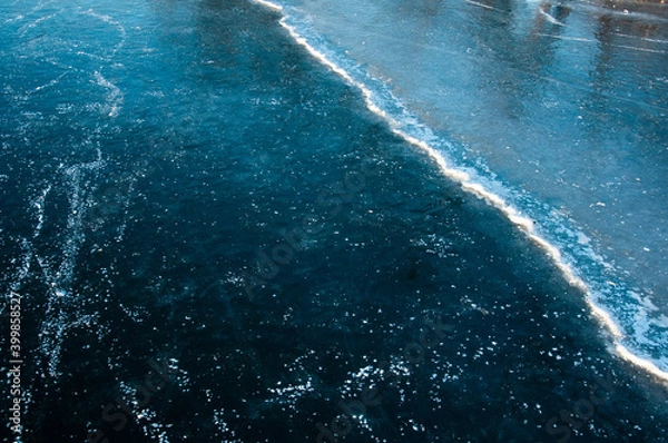 Fototapeta Abstract ice texture. Cracks in a piece of blue ice. Wave.