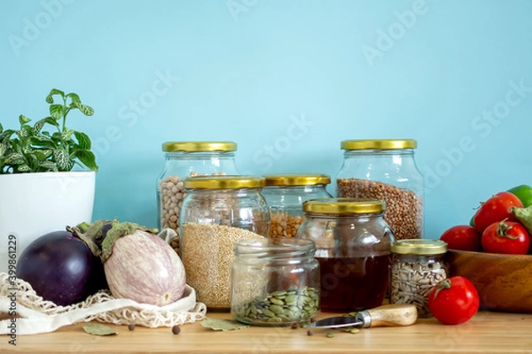 Obraz Zero waste healthy food-cereals, seeds, vegetables flat lay on grey background. Groceries in textile bags,glass jars, wooden bowl. Eco friendly plastic free low waste lifestyle.