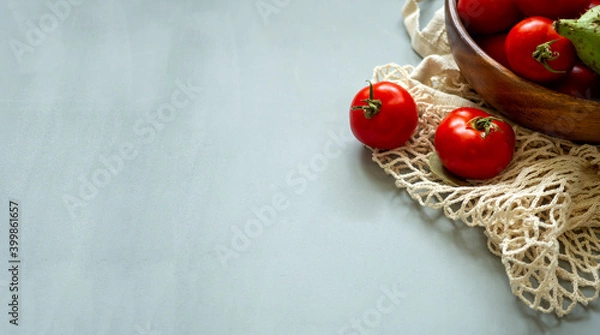 Fototapeta Healthy food vegetables on grey background. Groceries in recycle textile bags. Eco friendly plastic free low waste lifestyle. Zero waste bio food storage and shopping concept.