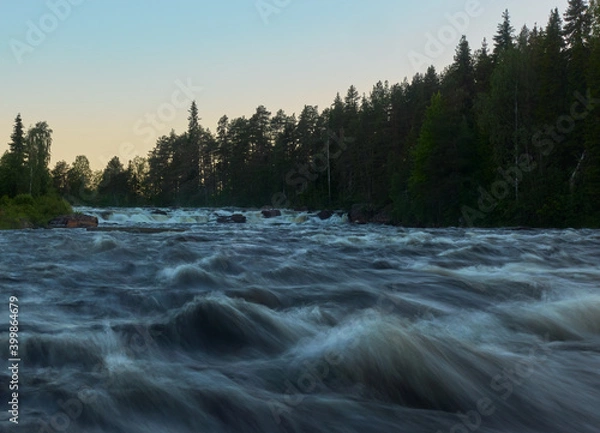 Fototapeta Kengis rapids on Torne river in Northern Sweden near border with Finland with midnight sun in early morning in July 2019.