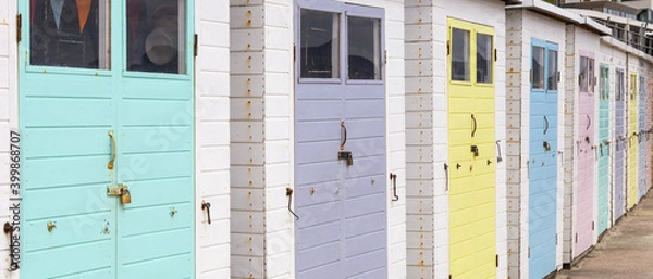 Obraz Row of beach huts at Lyme Regis, Dorset, UK. Pastel colours.