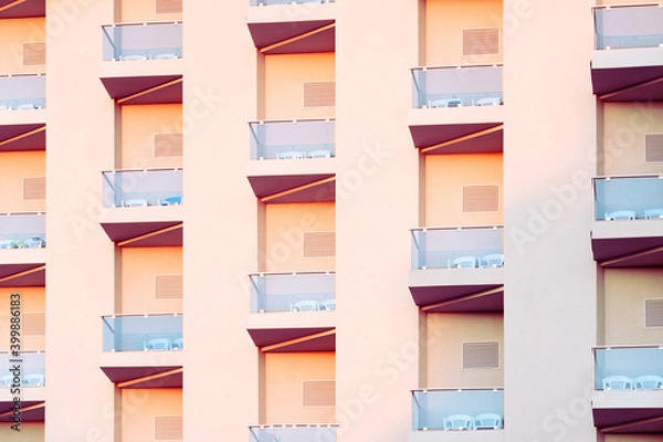Fototapeta Geometry in building facade design. Abstract details of repetitive patterns of balconies . in modern apartment building. Architecture design concept